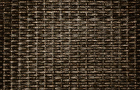 Dark color artificial rattan pattern. Background of basket structure close-up. Furniture backdrop.weaving texture of wicker baskets texture Wicker woven pattern for abstract background .の写真素材