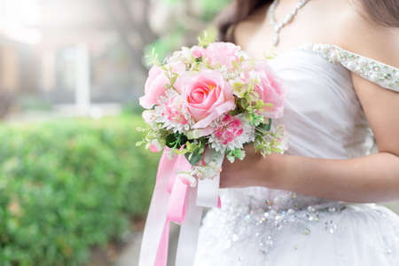 Bride holds a wedding bouquet, wedding dress, wedding ring,wedding detailsの写真素材
