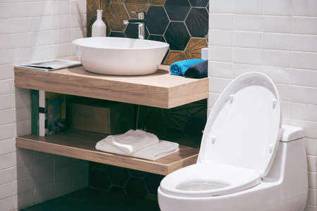 Modern spacious bathroom with bright tiles with toilet and sink. Side viewの写真素材