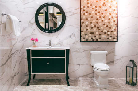 White toilet bowl in the bathroom with bright tiles with toilet and sink.の写真素材