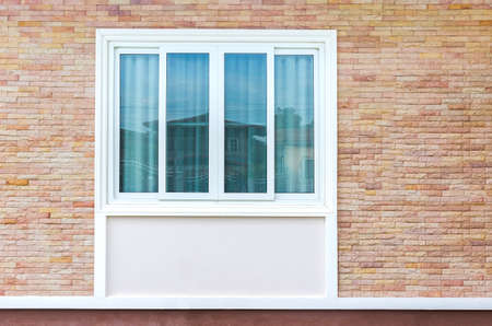 Old Brick Wall with White Window