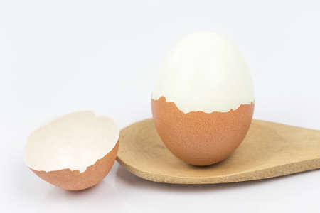 Boiled egg on white background. (Selective Focus, Focus on the front of the shell on the first egg)の写真素材