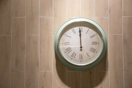 Antique clocks green vintage retro styles Hanging on the wall of brown, with space for text. indicates the time 12:00の写真素材