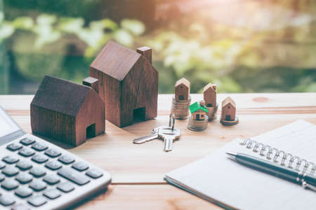 House placed on coins Men's hand is planning savings money of coins to buy a home concept concept...