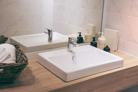 Spacious apartment - Modern wash basin in new bathroom interior. Bright space - a silver tap in wall...