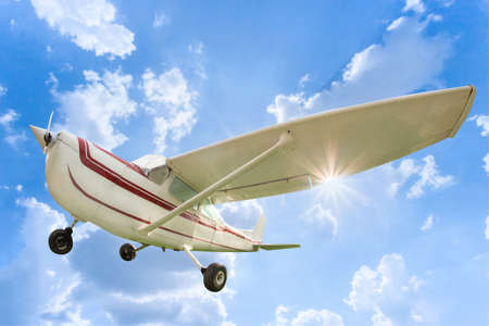 Upper wing aircraft on blue sky white clouds background. Model of steel ancient fight airplane