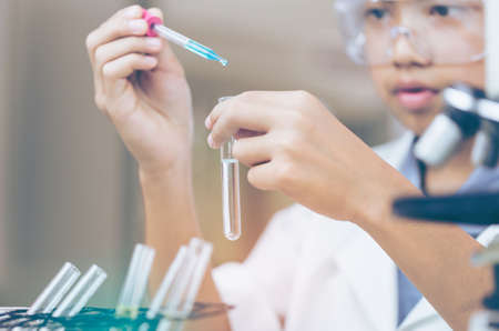Young Asian Scientist are certain activities on experimental science like mixing chemicals or entry...