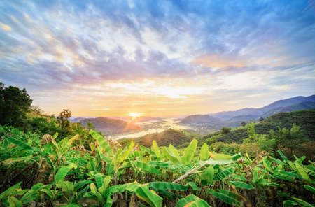 Scenic Landscape view in Sunrise in the morning with Isan mountain overlooking the Mekong river Landscape, view from top of mountain at Phu Huay Isan, Nong Khai Province, Thailand.の写真素材