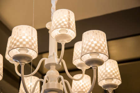 Close-up of a beautiful crystal chandelier Beautiful chandelier. luxury expensive chandelier hanging under ceilingの写真素材