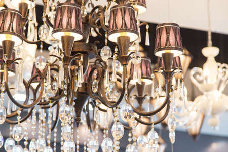 Close-up of a beautiful crystal chandelier. luxury expensive chandelier hanging under ceilingの写真素材