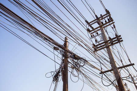 out of focus, Messy electrical cables in India. Uncovered optical fiber technology open air outdoors...