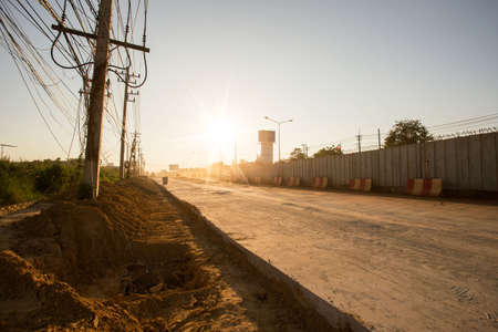 road currently under construction at to increase traffic, Sunset backgroundの写真素材