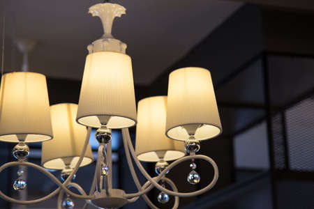 led light bulb in the industrial lamp is bright on the ceiling of the new warehouse with copy space,...