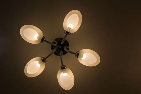 Close up on crystal of contemporary chandelier, is a branched ornamental light fixture designed to be mounted on ceilings or walls. Black backgroundの写真素材