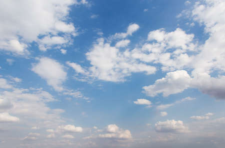 The vast sky and the white clouds float in the sky. The natural blue background has a breeze on a bright day in the summer.The sky and clouds are not the same shape as the weather.の写真素材