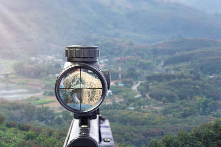 rifle target view on Natural Background. Image of a rifle scope sight used for aiming with a weaponの写真素材