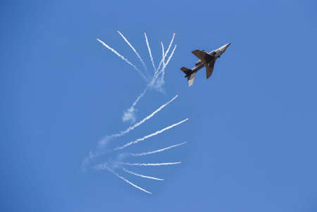 An Alpha Jet fighter jet in flight over airfield Udon Thani Airport Thailand, Children's Day is shown at the Udon Thani, shooting fireworksの写真素材