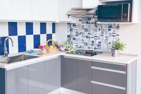 Electric stove. Frying pan is placed on a modern electric stove, black induction stove, cooker, hob or built in cooktop with ceramic top in Luxury kitchen interior .の写真素材