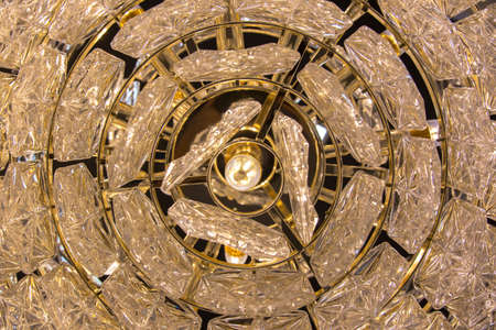 Close up on crystal of contemporary chandelier, is a branched ornamental light fixture designed to be mounted on ceilings or walls.の写真素材