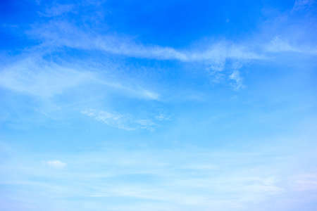 The vast sky and the white clouds float in the sky. The natural blue background has a breeze on a bright day in the summer.The sky and clouds are not the same shape as the weather.の写真素材