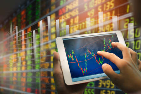 Businessman using tablet analyzing sales data and economic growth graph chart. Business strategy. Digital marketing.の写真素材