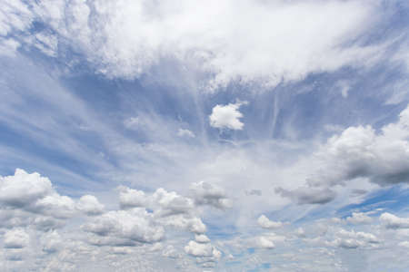 The vast sky and the white clouds float in the sky. The natural blue background has a breeze on a bright day in the summer.The sky and clouds are not the same shape as the weather.の写真素材