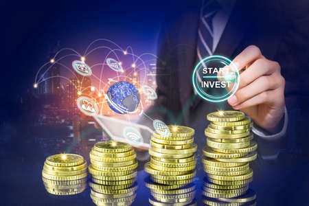 Startup button on a virtual screen touched by a businessman, Business man pointing at growth graph and business concept. investment, business, future technology and money concept.の写真素材