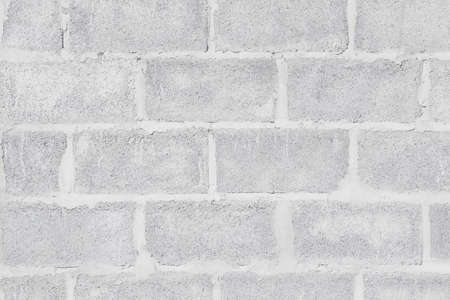 Abstract weathered high resolution texture old stucco light gray and aged paint white brick wall background in rural room, grungy blocks of stonework technology color horizontal architecture wallpaperの写真素材