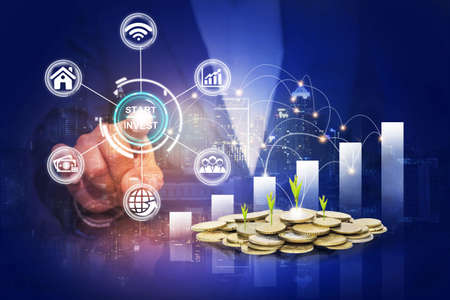 Startup button on a virtual screen touched by a businessman, Business man pointing at growth graph and business concept. investment, business, future technology and money concept.の写真素材