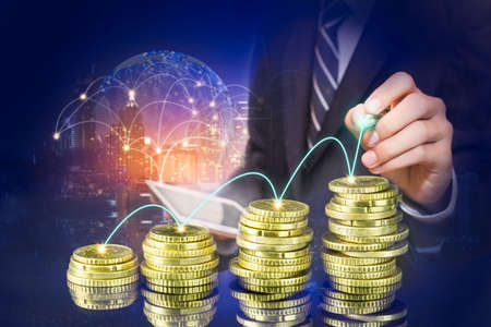 Business man pointing at growth graph and business concept. investment, business, future technology and money concept.の写真素材