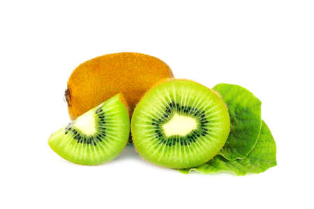 Ripe whole kiwi fruit and half kiwi fruit and green leaves isolated on white backgroundの写真素材