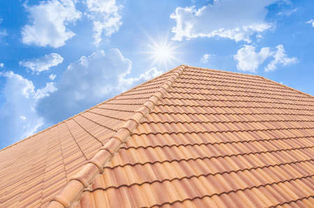Roof tiles and sky sunlight. Roofing Contractors concept Installing House roof.の写真素材