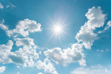 Sunny background, blue sky with white clouds and sun. The natural blue background has a breeze on a bright day in the summer.The sky and clouds are not the same shape as the weather.の写真素材