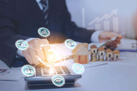 Plan to buy a house. The hands of businessmen who are pressing calculators in meeting rooms, business ideas, finance and accounting.の写真素材