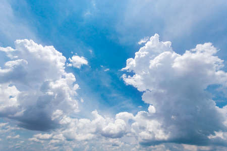 The vast sky and the white clouds float in the sky. The natural blue background has a breeze on a bright day in the summer.The sky and clouds are not the same shape as the weather.の写真素材