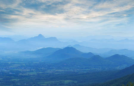landscape with silhouettes of blue mountains with mist and cold sunlight. Amazing mountain landscape. Beauty world.の写真素材