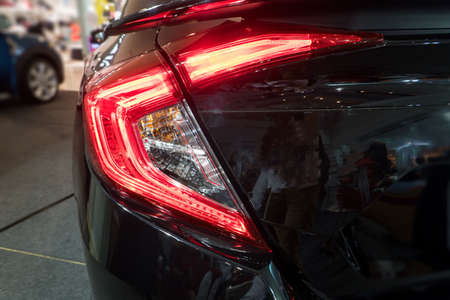 Detail on the rear light of a black.  black sport hybrid car rear light parts. Tail light of luxury sport carの写真素材