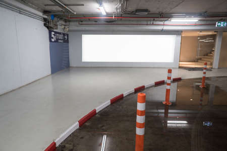 parking garage underground interior with blank billboard.Empty space car park interior at afternoon.Indoor parking lot.interior of parking garage with car and vacant parking lot in building.の写真素材