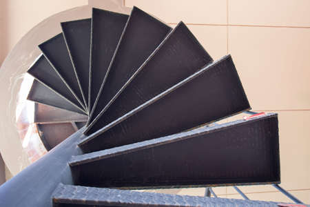Spiral steel staircase circular staircase decoration interior. travel and architecture background.spiral staircase dark colorの写真素材