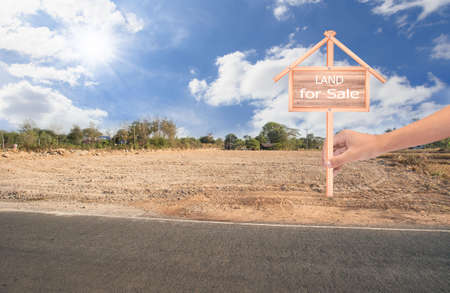 Empty dry cracked swamp reclamation soil, land plot for housing construction project with car tire print in rural area and beautiful blue sky with fresh air Land for sales landscape conceptの写真素材