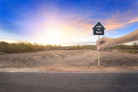 Empty dry cracked swamp reclamation soil, land plot for housing construction project with car tire print in rural area and beautiful blue sky with fresh air Land for sales landscape conceptの写真素材
