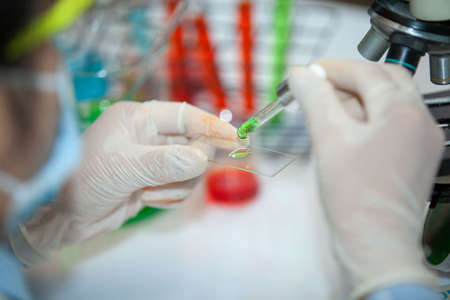 Health care researchers working in life science laboratory and analyzing microscope slides in research lab. New Epidemic Corona Virus. Corona virus outbreaking. Corona Virus in Lab.の写真素材