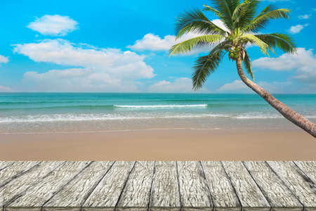 Top of wood table with blurred sea and coconut tree background - Empty ready for your product display montage. Concept of beach in summerの写真素材