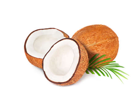 Coconut with half. Fresh raw coconut with palm leaves isolated on white background. High resolution imageの写真素材