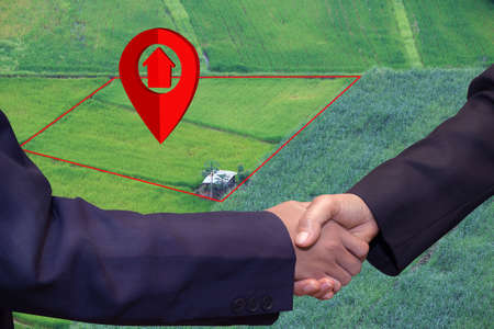 House symbol with location pin icon in real estate sale or property investment concept, Buying new home for family. Business handshake land purchaseの写真素材
