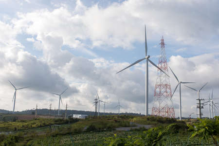 Wind turbines on the mountain and beautiful view after raining with giant cloudy flow and sun shy at...