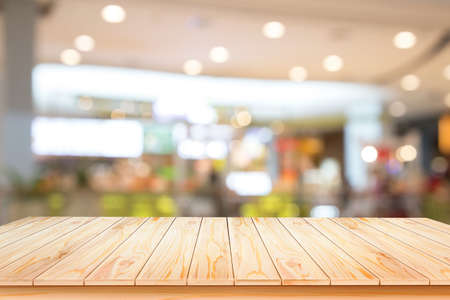 Wooden board empty table in front of blurred background. Perspective brown wood over blur in coffee shop - can be used for display or montage your products.Mock up for display of product.の写真素材