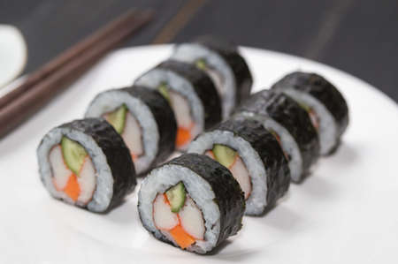 Sushi Rolls with shrimp on White background. Japanese traditional roll with prawn. Sushi set on a stone plate and dark concrete background. Sushi roll set and chopsticks. Fresh Japanese cuisine. asiaの写真素材