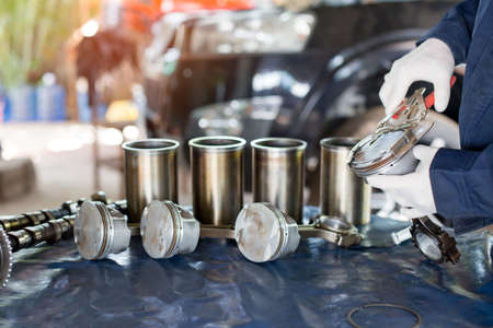 Auto mechanic working in garage. Repair service.の写真素材