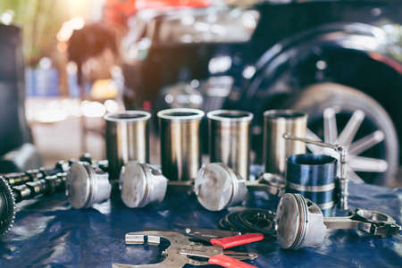 Auto mechanic working in garage. Repair service. The connecting rod, piston and cylinder block in a disassembled condition. maintenance repair at car service station for diagnosisの写真素材